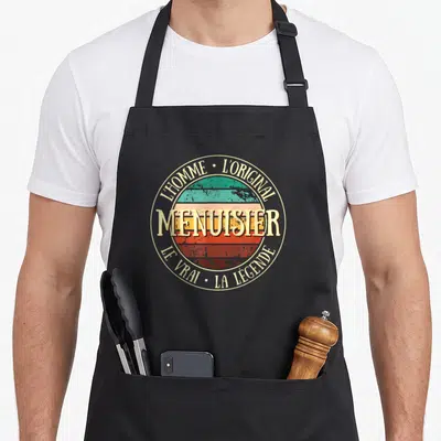 Tablier de cuisine noir avec un logo circulaire vintage affichant le mot menuisier et les mentions l'homme original et la légende.