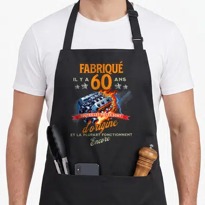 Tablier de cuisine noir avec illustration de moteur enflammé et texteFabriqué il y a 60 ans