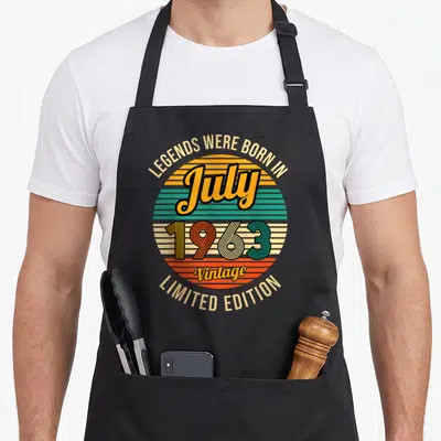 Tablier de cuisine noir avec motif circulaire vintage coloré affichant Les légendes sont nées en juillet 1963 Vintage Limited Edition.