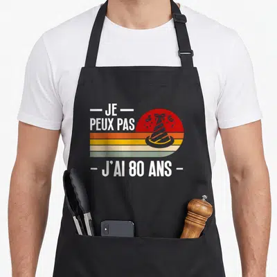 Tablier de cuisine noir avec motif vintage Je peux pas j'ai 80 ans et chapeau de fête coloré.
