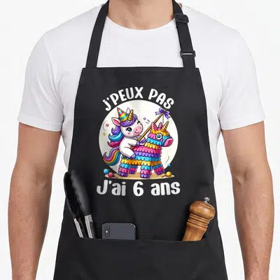 Tablier de cuisine noir avec licorne tenant une pinata et texte J'ai 6 ans