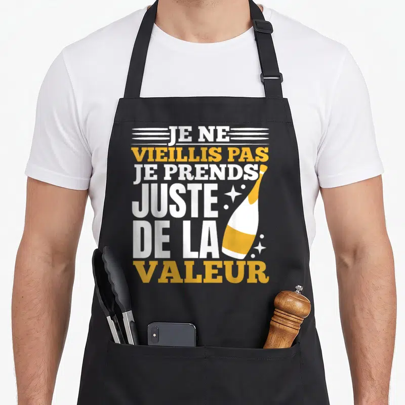 Tablier de cuisine noir avec inscription Je ne vieillis pas je prends de la valeur et illustration bouteille champagne or blanc