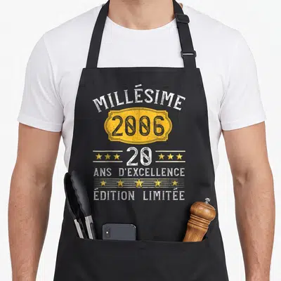 Tablier de cuisine noir avec inscription millésime 2006, « 20 ans d'excellence », « édition limitée » et étoiles dorées.