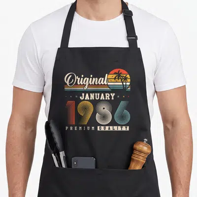 Tablier de cuisine noir avec motif rétro Original Janvier 1986 Premium Quality et soleil aux palmiers.
