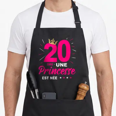 Tablier de cuisine noir avec un grand 20 rose, une couronne dorée et le texte Une Princesse Est Née 2002.