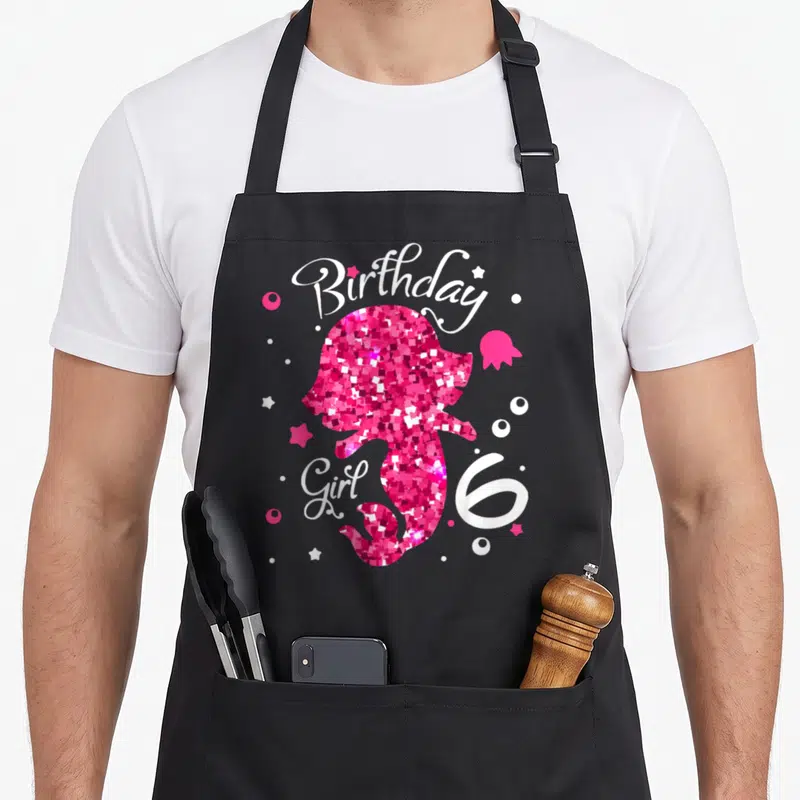 Tablier de cuisine noir avec silhouette rose pailletée de fille, texte anniversaire Girl et chiffre 6 blanc.