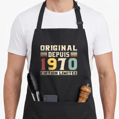 Tablier de cuisine noir avec motif vintage affichant Original depuis 1970 en lettres colorées.