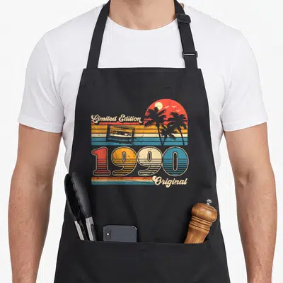 Tablier de cuisine noir avec motif rétro 1990, cassette audio, palmiers et texte Limited Edition Original coloré.