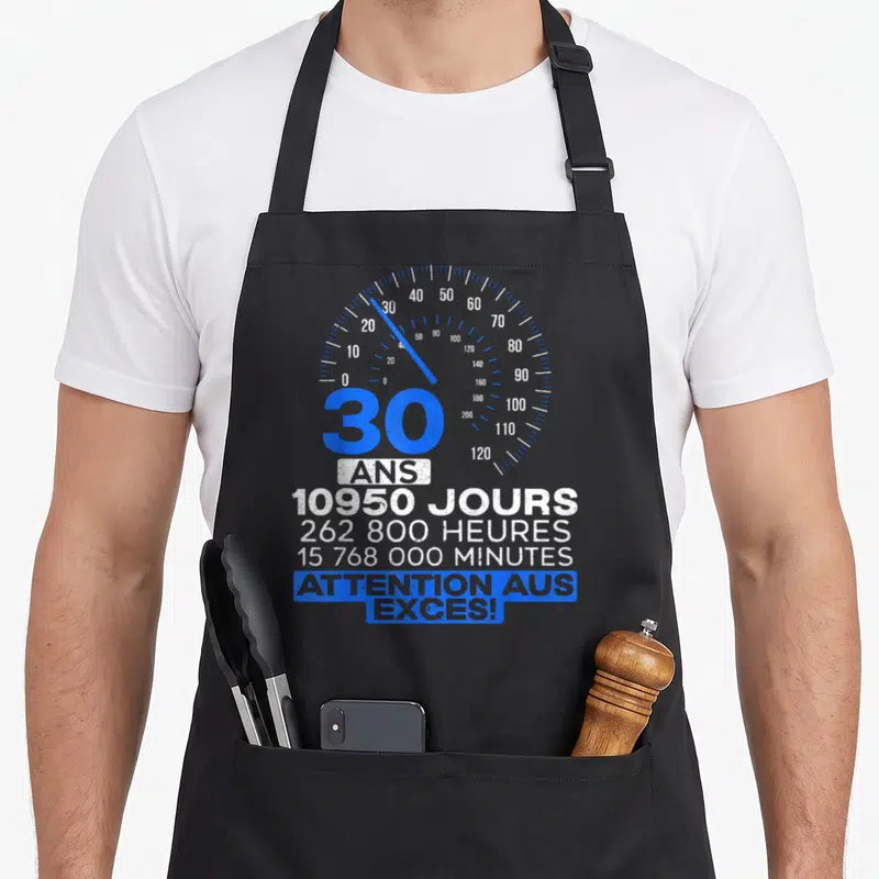 Tablier de cuisine noir avec compteur bleu indiquant 30 ans et 10950 jours ainsi que la mention attention aus exces en bas.