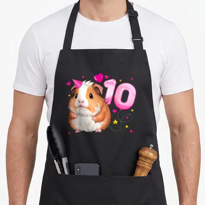 Tablier de cuisine noir avec un cochon d'Inde portant une casquette rose, le chiffre 10 en ballon et des étoiles dorées.