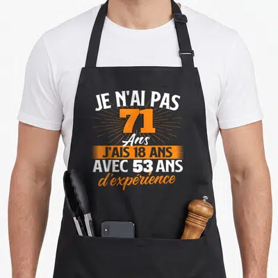 Tablier de cuisine noir avec inscription Je n'ai pas 71 ans j'ais 18 ans et 53 ans d'expérience en orange et blanc.