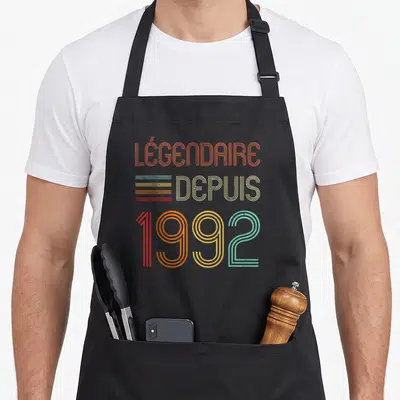 Tablier de cuisine noir avec typographie rétro multicolore Légendaire depuis 1992