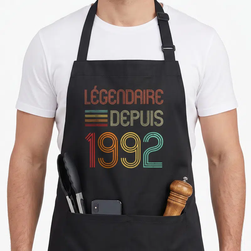 Tablier de cuisine noir avec typographie rétro multicolore Légendaire depuis 1992