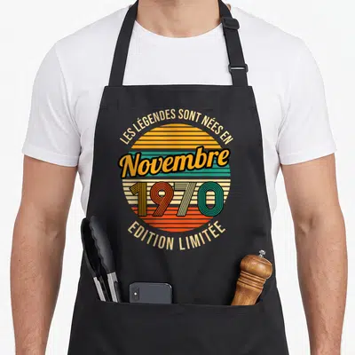 Tablier de cuisine noir avec motif circulaire retro orange vert et texte Les Légendes sont nées en Novembre 1970 « Édition Limitée »