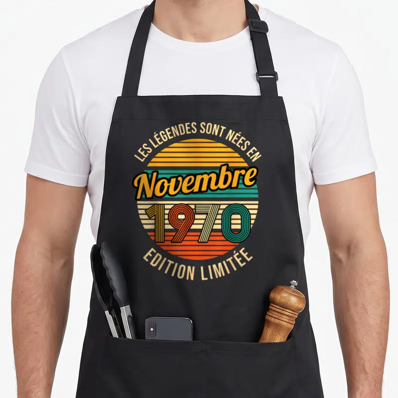 Tablier de cuisine noir avec motif circulaire retro orange vert et texte Les Légendes sont nées en Novembre 1970 « Édition Limitée »