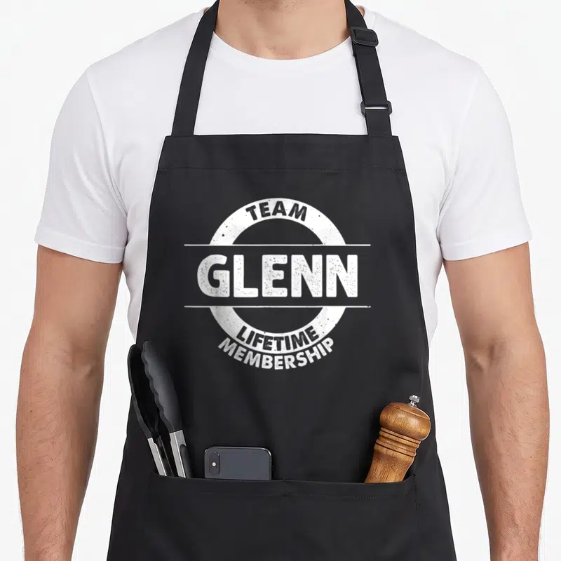 Tablier de cuisine noir avec logo blanc Team Glenn Lifetime Membership style badge circulaire.