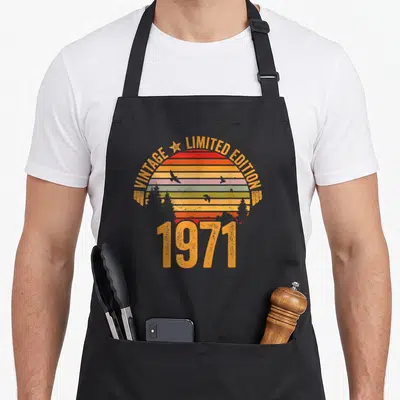 Tablier de cuisine noir avec motif rétro 1971 Limited Edition soleil couchant et oiseaux en silhouette.
