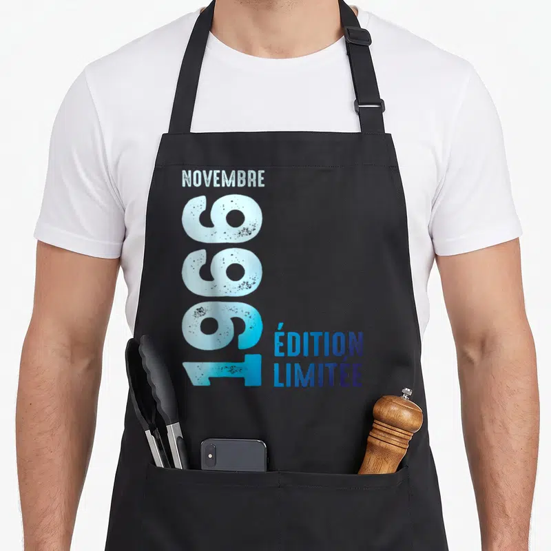 Tablier de cuisine noir avec l'inscription « Édition Limitée » 1966 Novembre en bleu dégradé et effet vieilli.