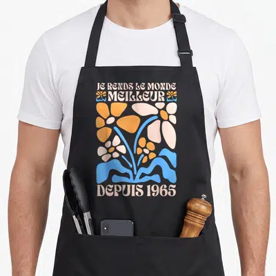Tablier de cuisine noir avec inscription Je rends le monde meilleur depuis 1965 et motifs floraux rétro orange bleu rose pâle