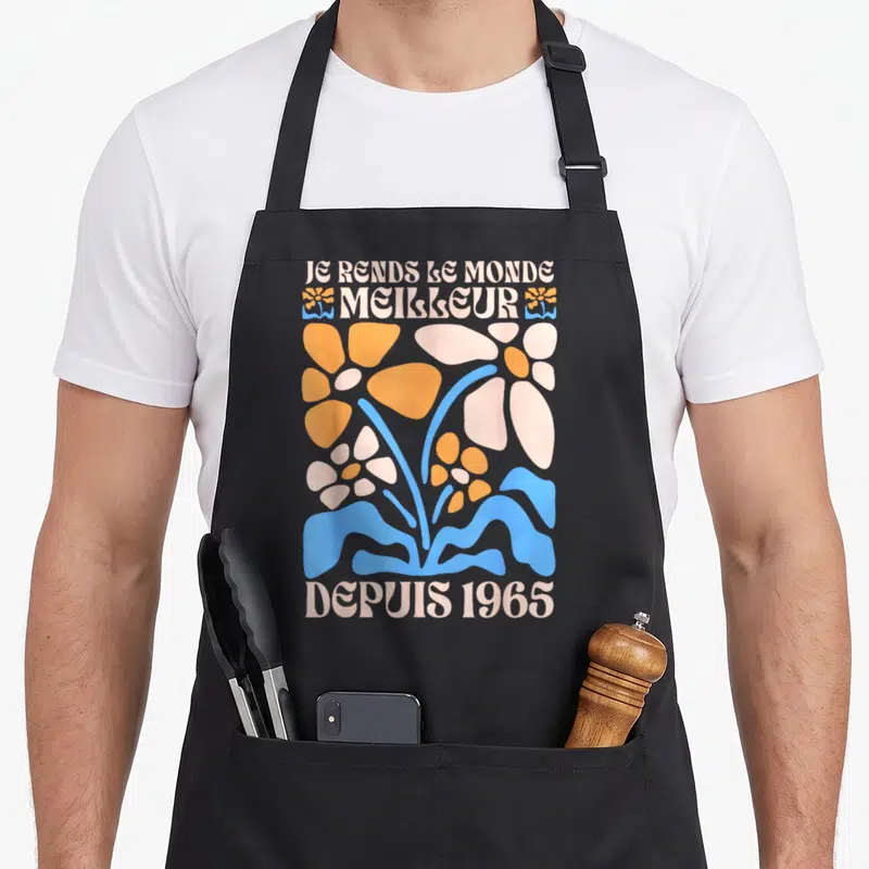 Tablier de cuisine noir avec inscription Je rends le monde meilleur depuis 1965 et motifs floraux rétro orange bleu rose pâle