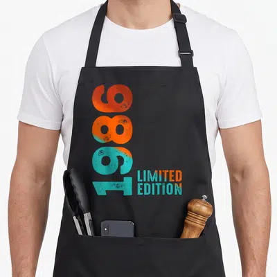 Tablier de cuisine noir avec inscription verticale 1986 Limited Edition orange et turquoise style rétro.