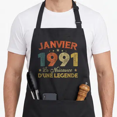 Tablier de cuisine noir avec inscription vintage Janvier 1991 La Naissance D'une Légende en couleurs pastel.