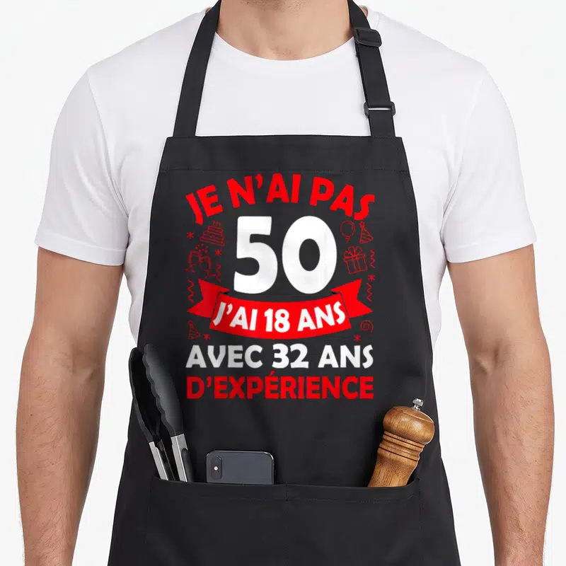 Tablier de cuisine noir avec inscription Je n'ai pas 50 ans pour 50e anniversaire et motifs de fête rouges.