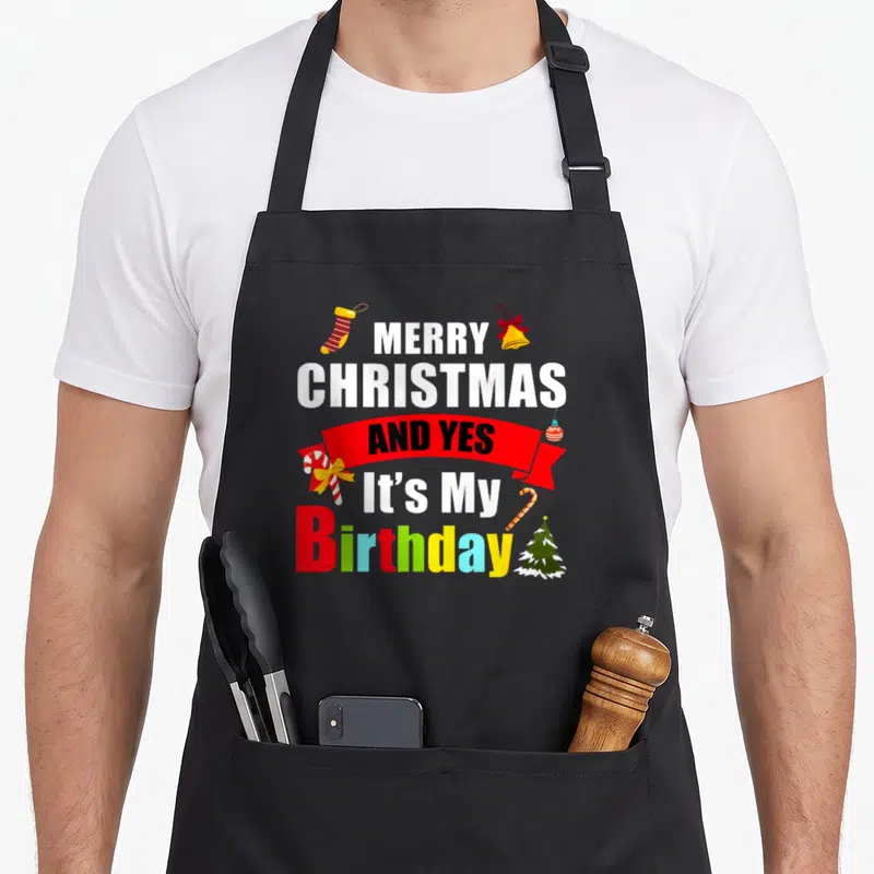 Tablier de cuisine noir avec inscription Joyeux Noël et yes its my anniversaire coloré et décorations de fêtes.