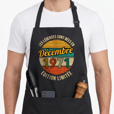Tablier de cuisine noir avec motif circulaire retro couleur soleil rayé orange vert beige et texte Les Legendes Sont Nees En Decembre 1971 Edition Limitée