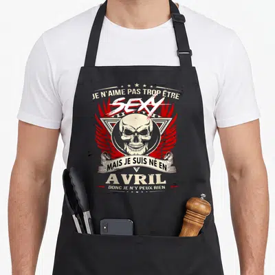 Tablier de cuisine noir avec motif crâne ailes rouges et texte Je n'aime pas trop être sexy mais je suis né en avril donc je n'y peux rien
