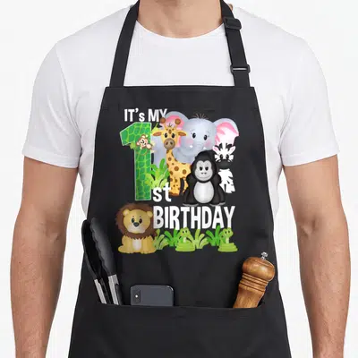Tablier de cuisine noir avec illustration animaux jungle et texte It's My 1st anniversaire coloré