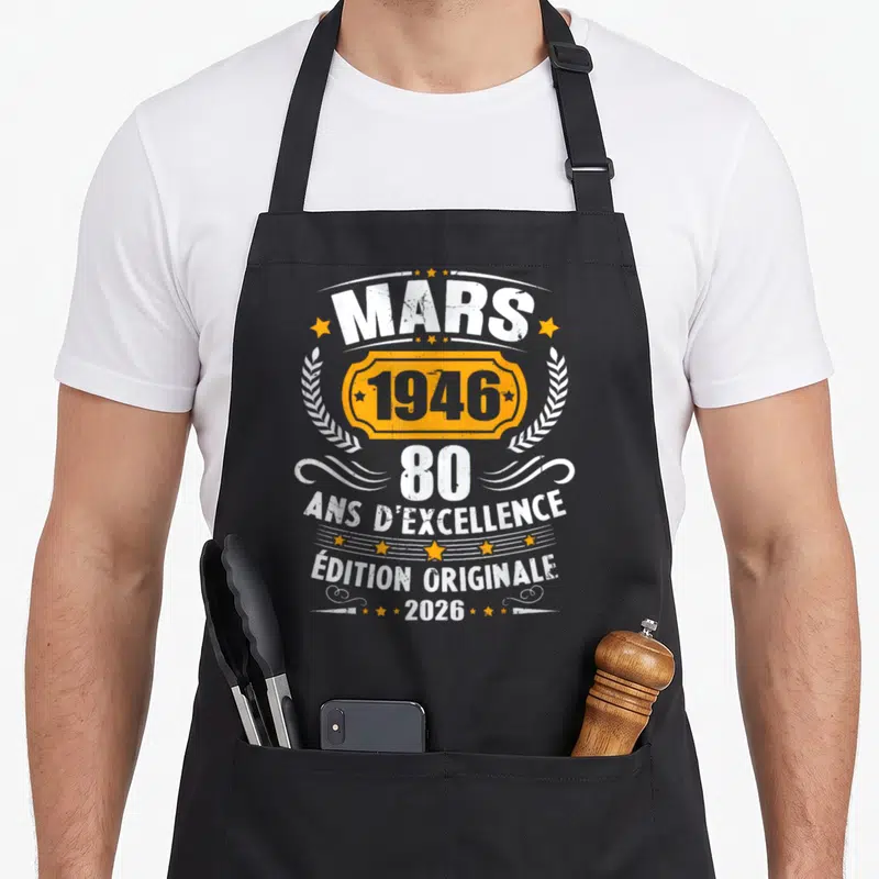 Tablier de cuisine noir avec inscription vintage Mars 1946 80 ans d'excellence Édition originale 2026 en blanc et orange.