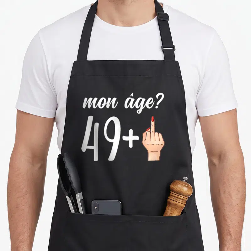 Tablier de cuisine noir avec inscription mon âge 49 plus et illustration d'une main levée