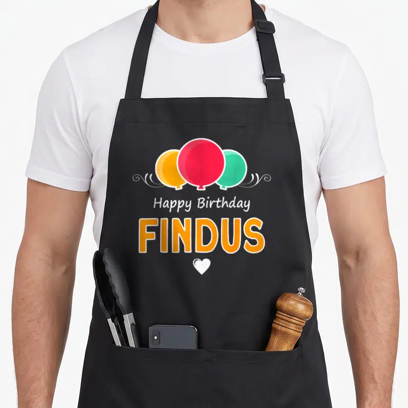 Tablier de cuisine noir avec inscription Happy anniversaire Findus et trois ballons colorés ornés d'un cœur blanc.
