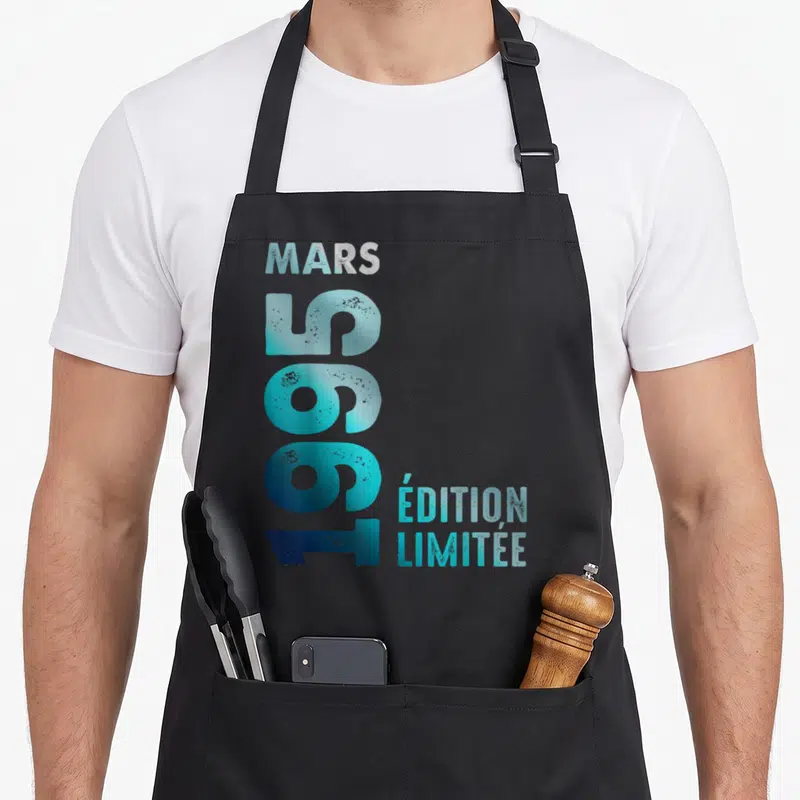 Tablier de cuisine noir avec inscription verticale Mars 1995 en bleu cyan dégradé et effet vieilli.