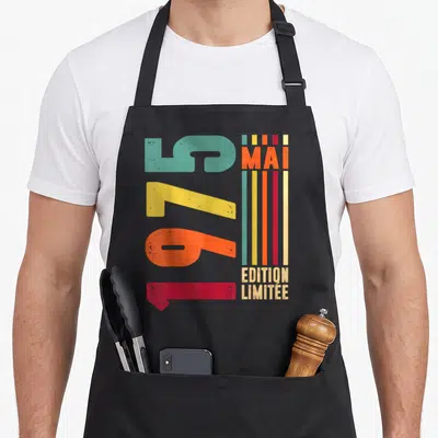 Tablier de cuisine noir avec les chiffres 1975 et le texte « Édition Limitée » en couleurs vives.