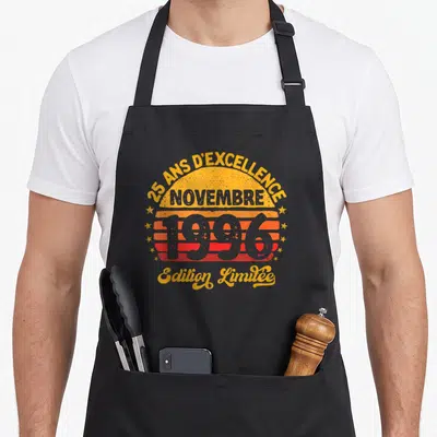 Tablier de cuisine noir avec un soleil rétro orange et rouge portant les mots 25 ans d'excellence novembre 1996 Edition Limitée