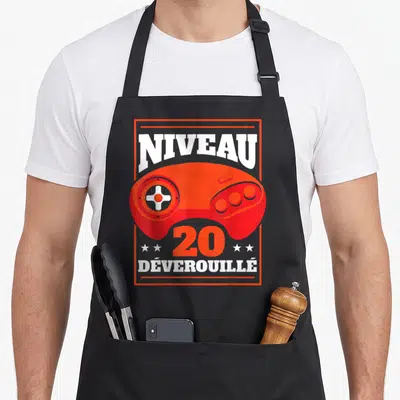 Tablier de cuisine noir avec illustration manette orange et texte Niveau 20 Déverouillé