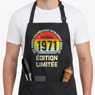 Tablier de cuisine noir avec motif rétro célébrant février 1971 et des années d'expérience totalement géniales.