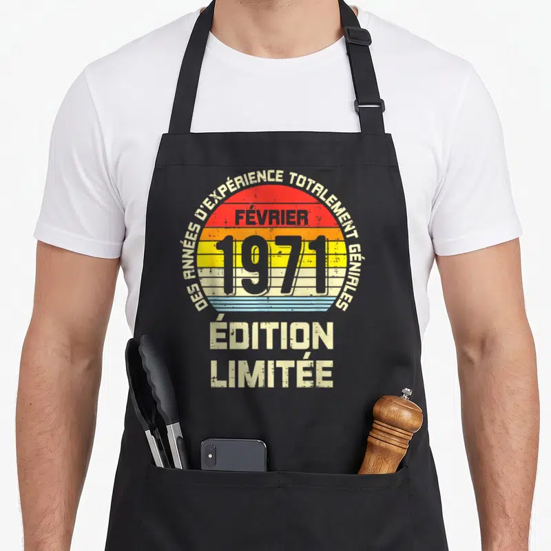 Tablier de cuisine noir avec motif rétro célébrant février 1971 et des années d'expérience totalement géniales.