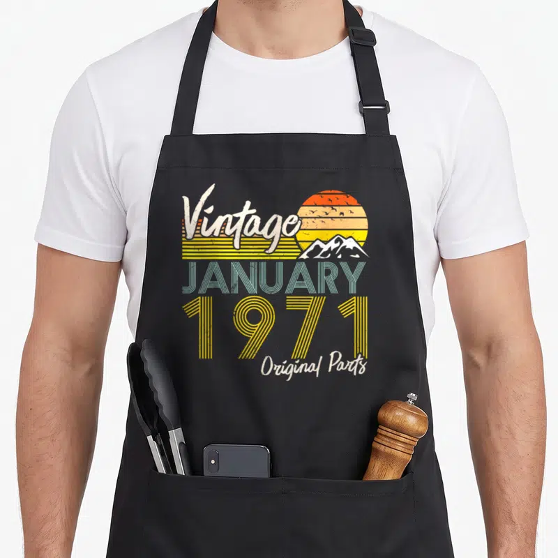 Tablier de cuisine noir avec motif vintage January 1971 Original Parts et soleil rétro.