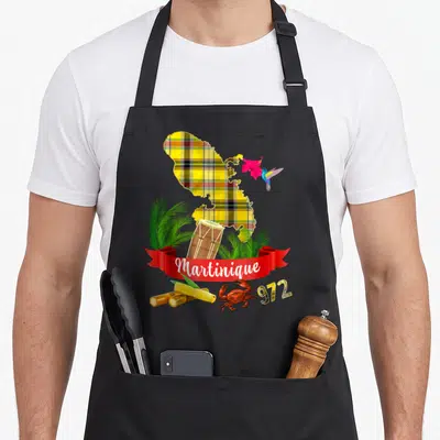 Tablier de cuisine noir avec carte Martinique madras, colibri, hibiscus, tambourin, cannes à sucre, crabe et inscription 972.
