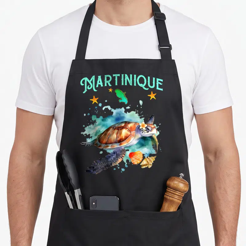 Tablier de cuisine noir avec illustration d'une tortue marine, de coquillages et du mot Martinique en turquoise.
