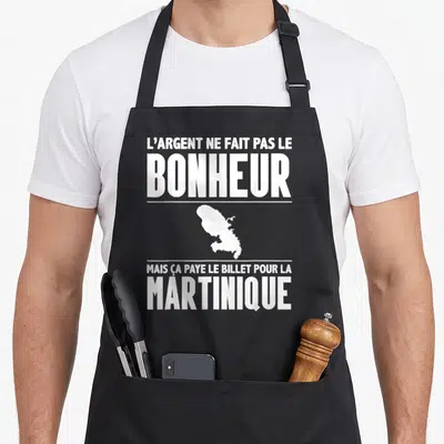 Tablier de cuisine noir avec inscription blanche L'argent ne fait pas le bonheur mais ça paye le billet pour la Martinique et silhouette de l'île.
