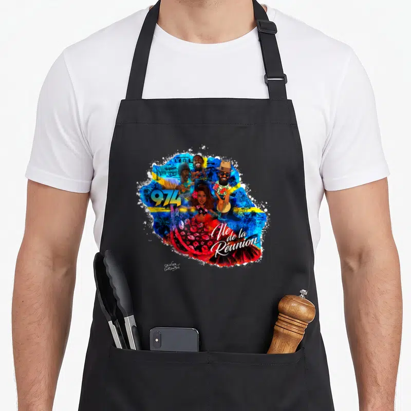 Tablier de cuisine noir avec une illustration colorée représentant l'île de la Réunion et des personnages musicaux.
