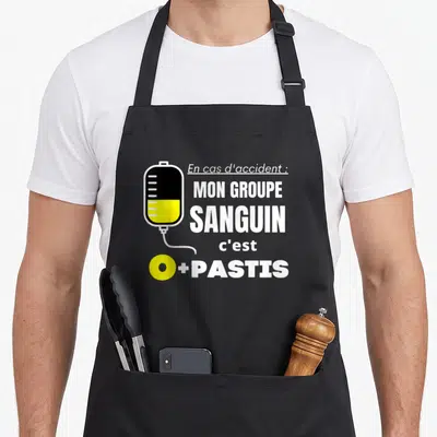 Tablier de cuisine noir avec illustration de perfusion et texte En cas d'accident mon groupe sanguin c'est O plus Pastis