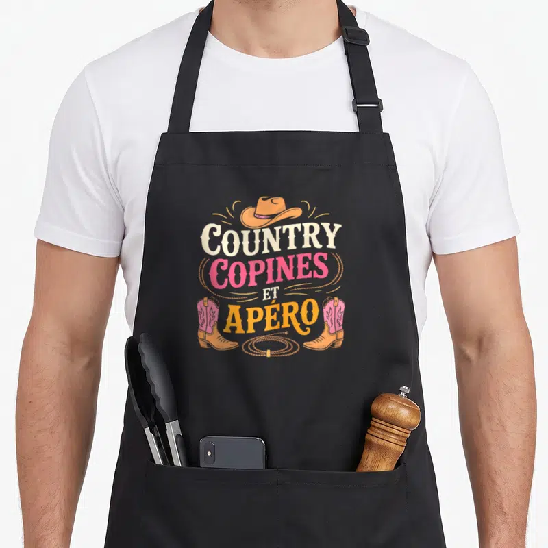 Tablier de cuisine noir avec motif Country Copines et Apéro illustré par un chapeau cowboy et des bottes roses.