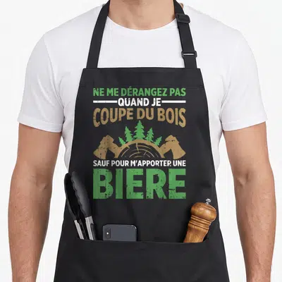 Tablier de cuisine noir avec inscription Ne me dérangez pas quand je coupe du bois sauf pour m'apporter une bière illustré d'un tronc d'arbre.