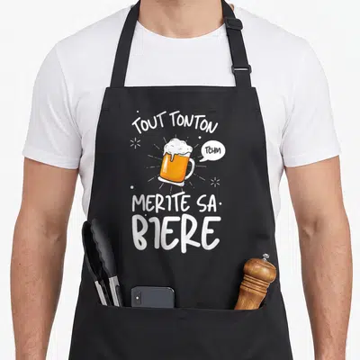 Tablier de cuisine noir avec illustration de verre de bière et texte tout tonton mérite sa bière