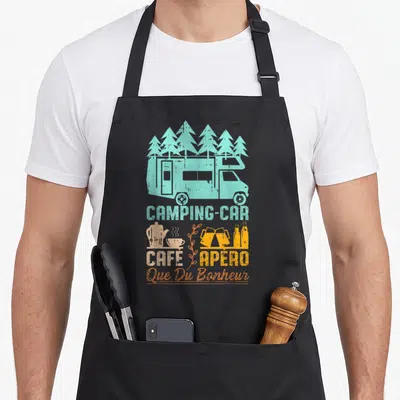 Tablier de cuisine noir avec illustration vintage d'un camping-car, de café, d'apéro et l'inscription Que Du Bonheur en orange.